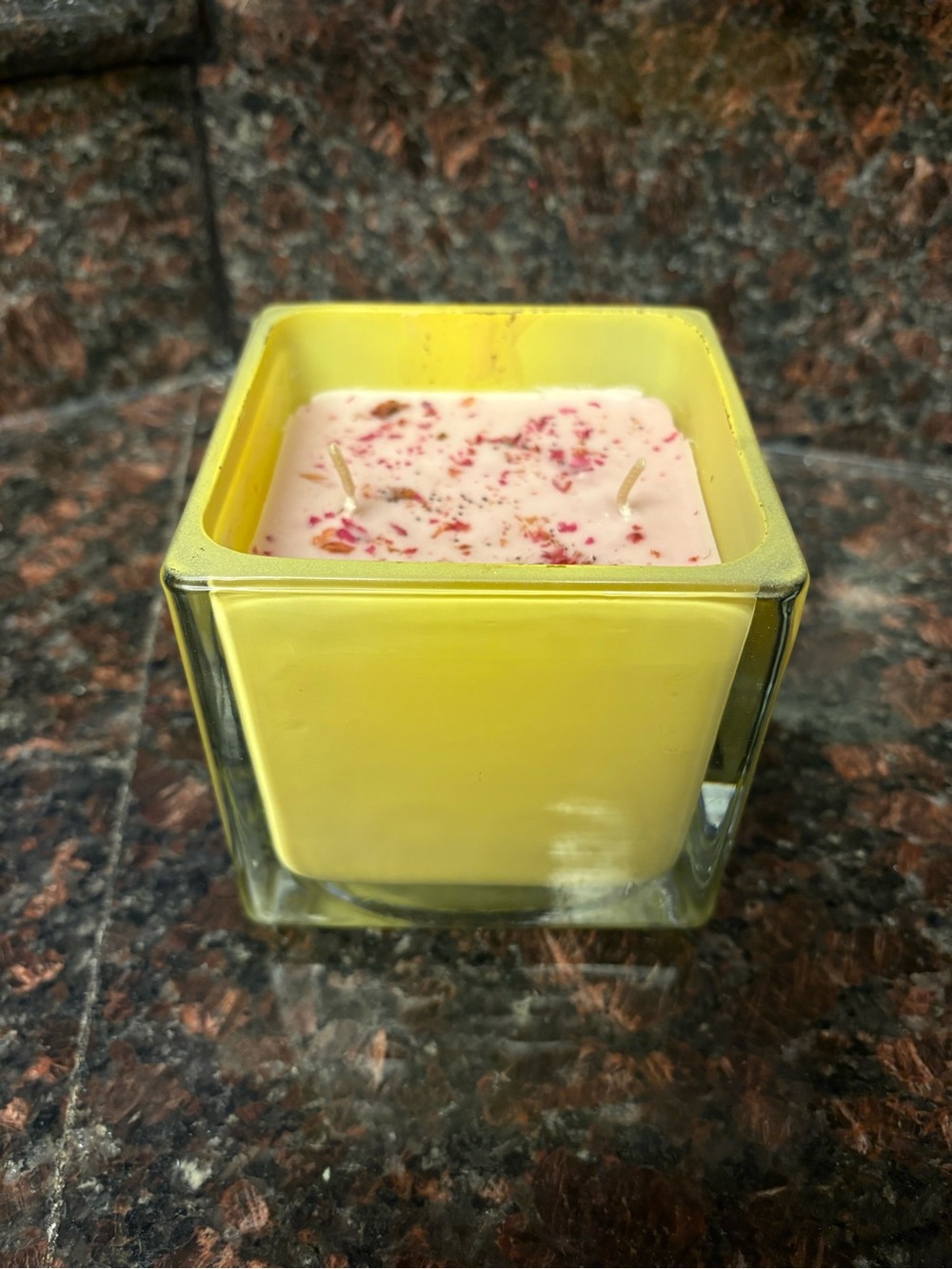 Upcycled candle rose scented wax poured into a thrifted vessel with rose petals